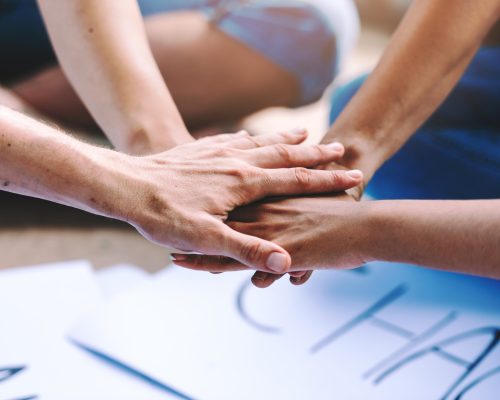 Close up of people volunteer teamwork putting hands together,Stack of hands,Unity and teamwork on world environment day.